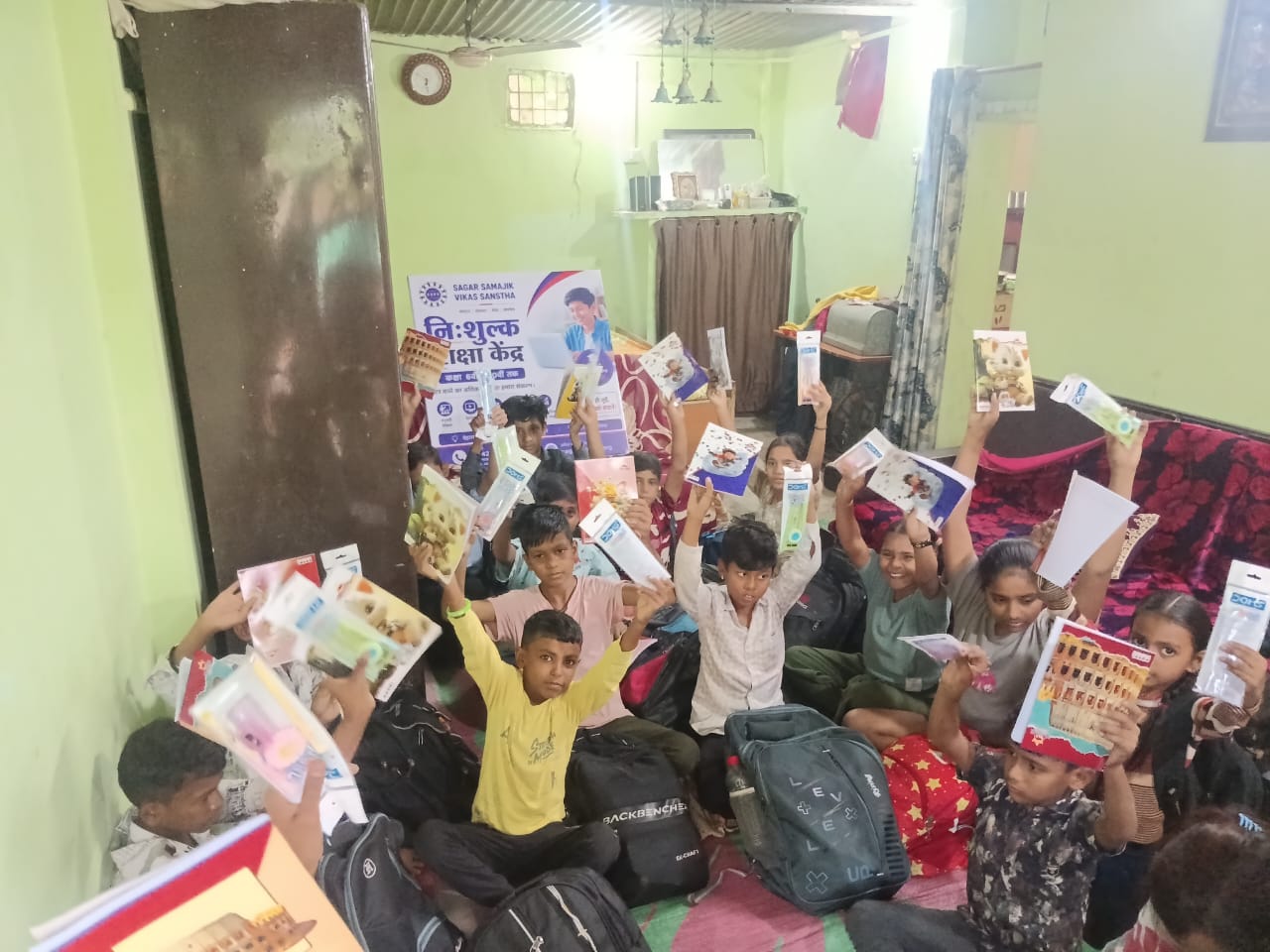 Children holding study materials at SSVS Dilip Nagar free education centre