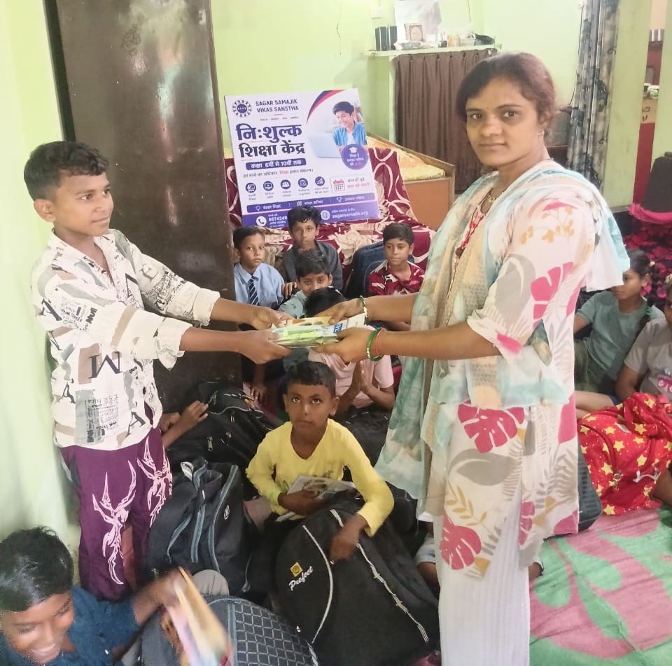 SSVS volunteer distributing books to children at the free education centre